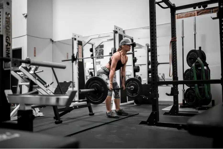 Woman performing a deadlift in a strength gym