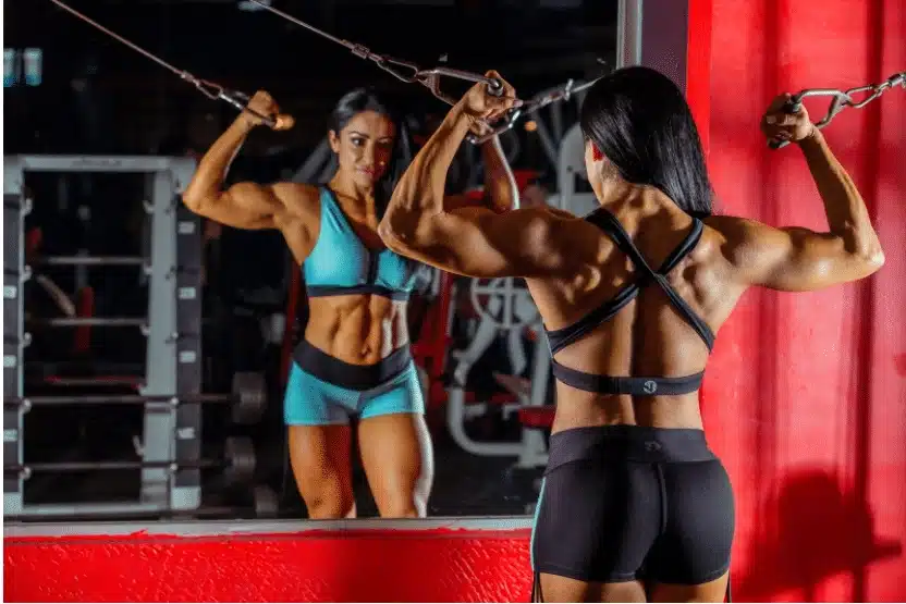 Woman performing cable flyes in the gym
