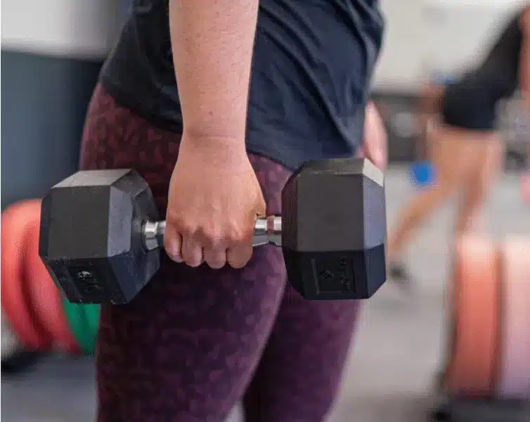 woman holding dumbbells strength ambassadors