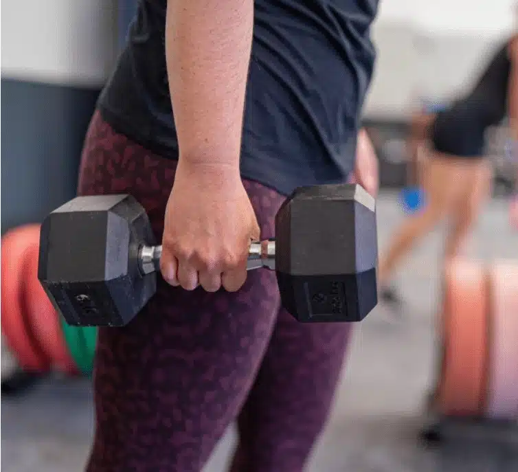 woman holding dumbbells strength ambassadors