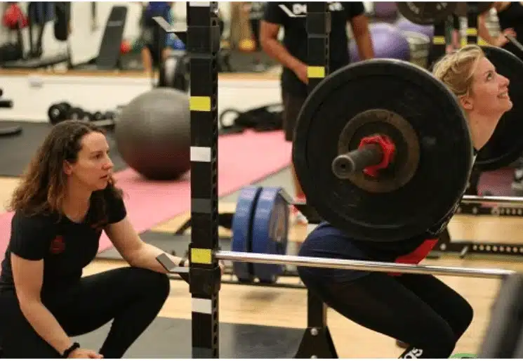 sally moss instructing a client's in the gym