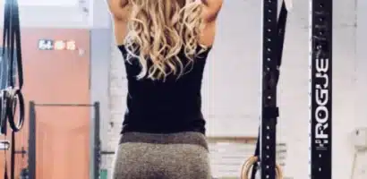 Woman performing pull-ups on a Rogue rig